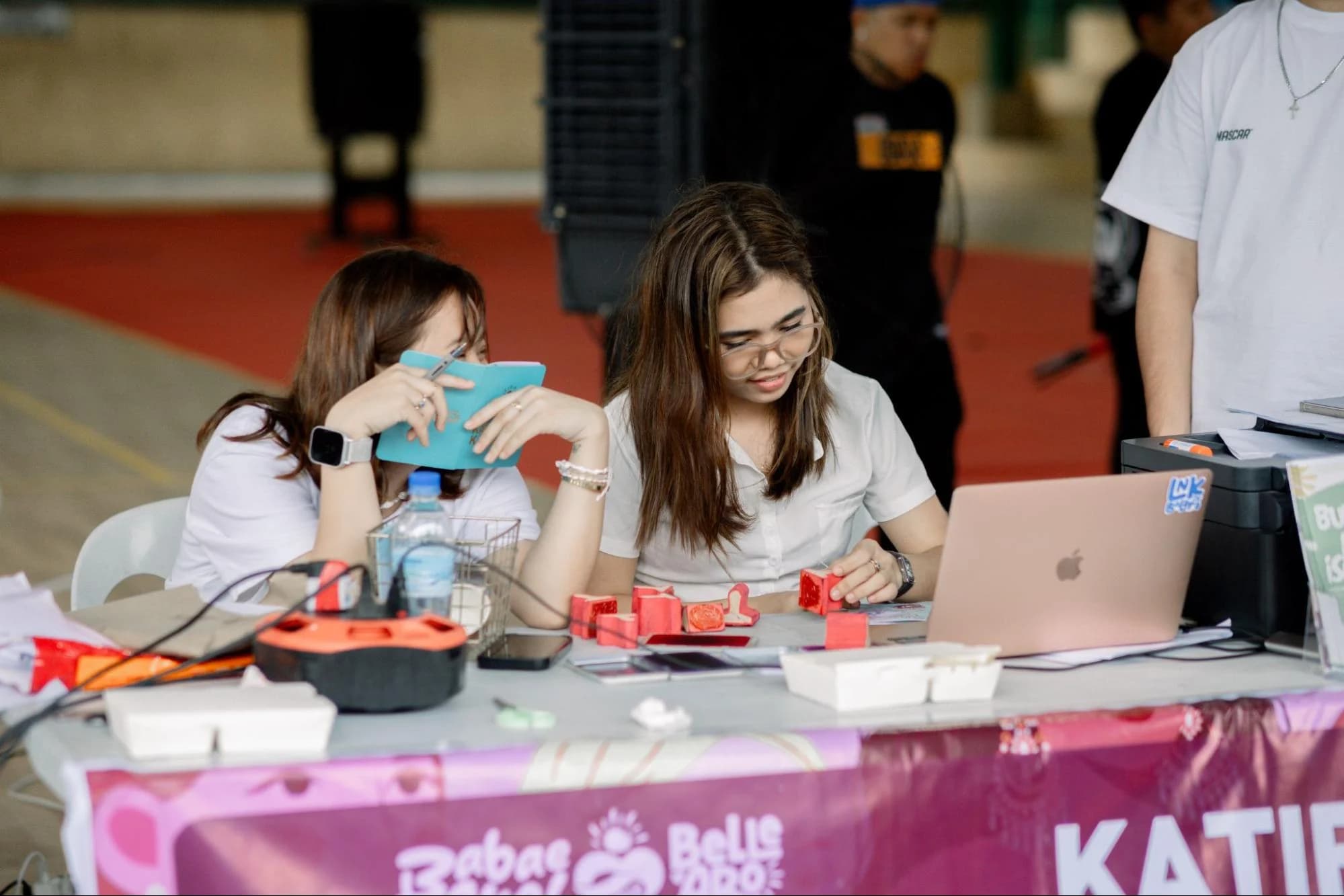 ProjectKAYO volunteers recording Passbook participation at a community booth